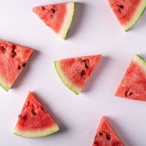 A flat lay image of juicy watermelon slices on a white background, perfect for summer themes.